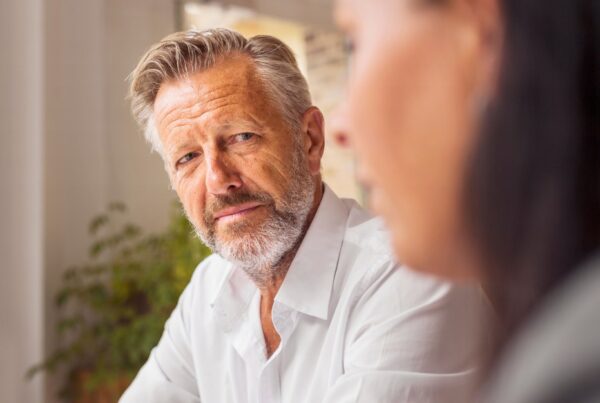 Middle-aged man talking to a lawyer about how to remove an executor