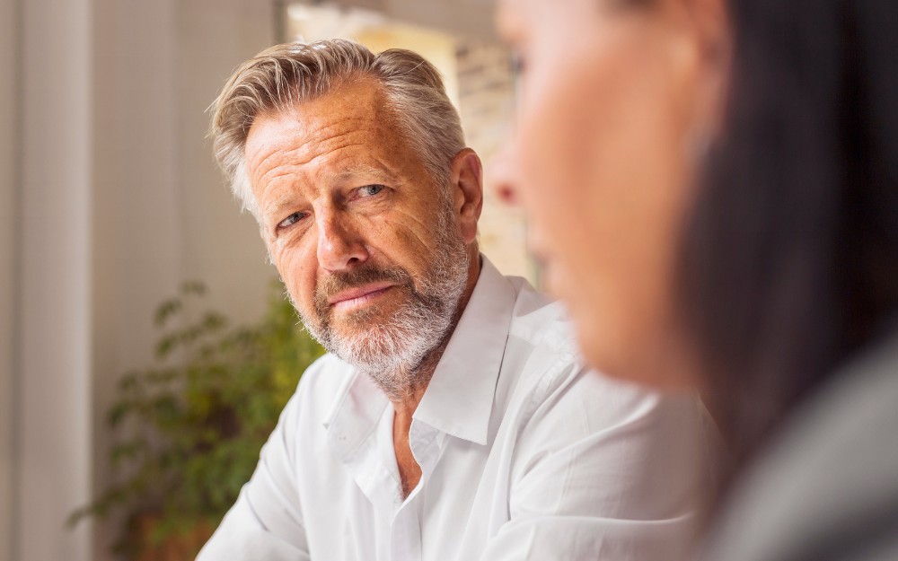 Middle-aged man talking to a lawyer about how to remove an executor